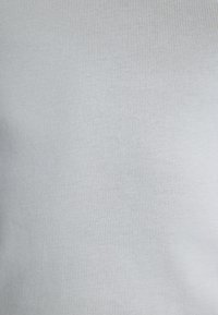 Light blue ribbed fabric with a smooth texture and subtle sheen. The pattern features thin, vertical stripes and minimal stretch.