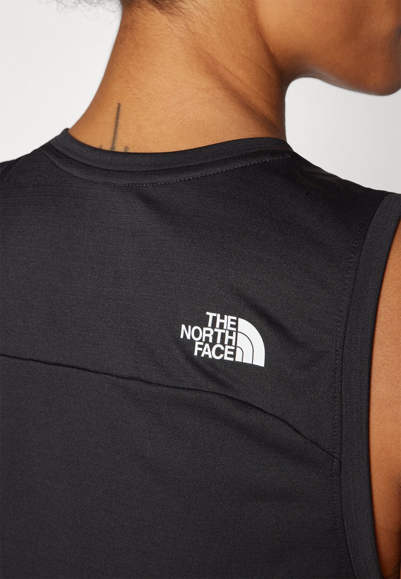 Camiseta atlética negra sin mangas hecha de material suave; presenta un logo blanco de "The North Face" en la parte superior de la espalda.