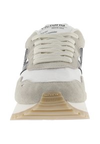 Sneaker in white, gray suede, and textured material. Features prominent laces, a cushioned sole, and logo detail on the tongue.