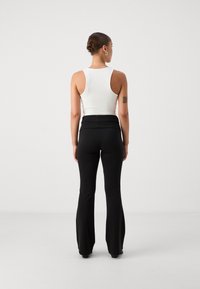 Gina Tricot Petite SOFT TOUCH PETITE FOLDED FLARE TROUSERS - Hlače - black