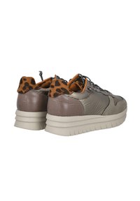 Zapato que presenta una combinación de materiales texturizados en color beige y marrón, con-acentos de estampado de leopardo en el talón y una gruesa suela blanca para mayor amortiguación.