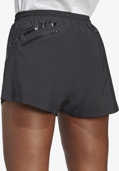 Pantaloni sportivi grigio scuro con una texture intrecciata, vita elastica e due tasche con zip sul retro.