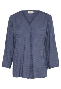 Blouse bleue à manches longues avec une texture subtile à pois, col en V et détail de pli à l'avant.