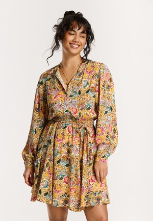 Floral dress in lightweight fabric featuring a vibrant yellow background, long sleeves, a cinched waist, and a flared skirt.