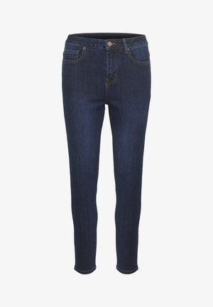 Tamsiai mėlynos aptemptos džinsinės kelnės turi lygią džinsinio audinio tekstūrą, standartines kišenes ir priekinį užsegimą su mygtuku. Siūlės yra kontrastingos geltonos spalvos.