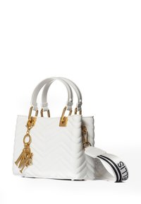 Handtasche mit weißem Zickzackmuster, goldenen Beschlägen und Schlüsselanhänger-Akzenten. Verfügt über zwei Griffe und einen abnehmbaren gestreiften Schultergurt.