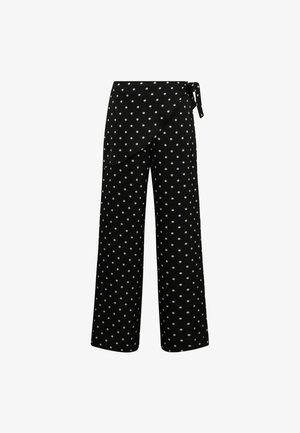 Schwarze weit geschnittene Hose mit Wickeldesign, cremefarbenen Punkten und einem dekorativen Knoten in der Taille, aus einem glatten Stoff gefertigt.