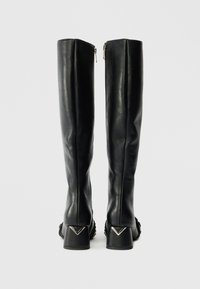 Black leather knee-high boots with a sleek design, featuring a textured heel and silver hardware accents at the base. Zipper closure on the back.