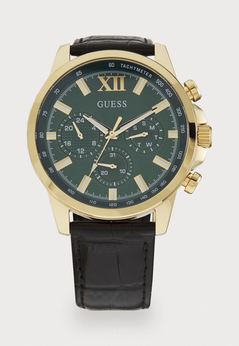 Montre chronographe dorée avec un cadran vert, un bracelet en cuir noir et plusieurs sous-cadrans. Comprend des marqueurs d'heure lumineux et un tachymètre.