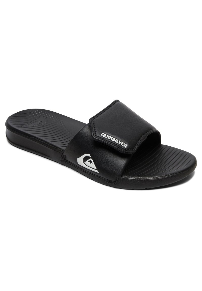 Black slide sandals made of synthetic material. Features a wide strap with "Quiksilver" logo, textured footbed, and grooved sole for grip.