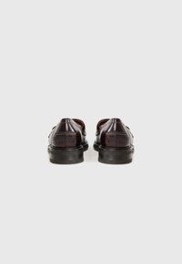 Burgundy leather shoes with a smooth finish, rounded toe, stitched accents, and a black rubber sole, viewed from the back.