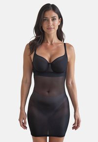 Rete nera modellante slip con spalline regolabili, corpo aderente e design senza cuciture, che si estende fino a metà coscia.
