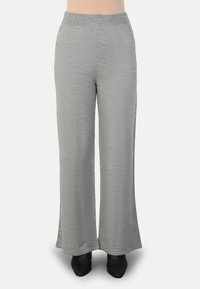 Light gray wide-leg pants made of textured fabric, featuring an elastic waistband and a loose fit, paired with black footwear.