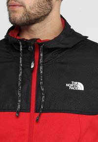 The North Face Fleecová bunda - red
