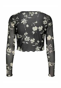 Top lungo nero trasparente con un motivo floreale bianco. Design accorciato con bordi scallop e vestibilità rilassata. Texture traslucida.