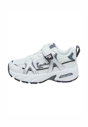 White athletic shoe with mesh and synthetic materials, featuring a Velcro strap, black accents, and notable logo details on the sides.