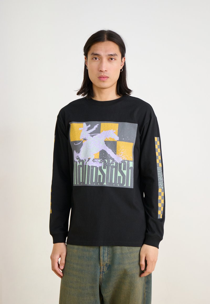 Schwarzes Langarmshirt mit einem grafischen Druck in Lila, Gelb und Grau. Lockere Passform mit karierter Musterung an den Ärmeln. Aus weichem Baumwollstoff.