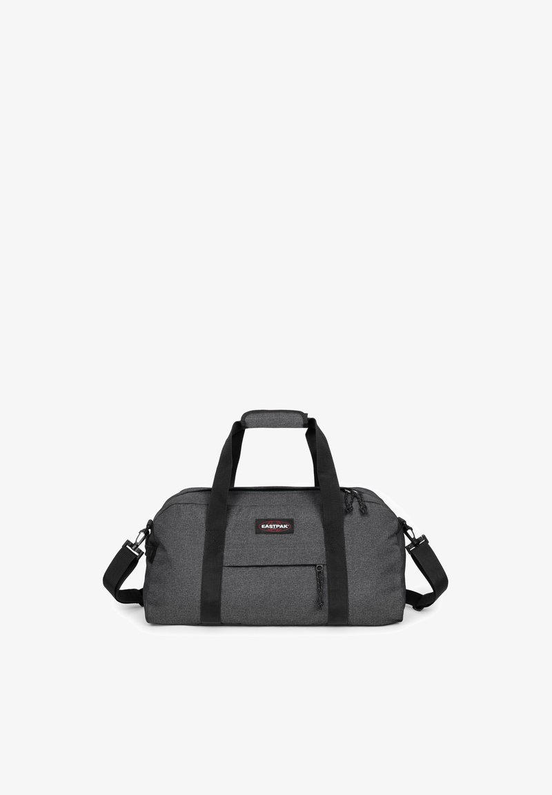 Borsa da viaggio in tessuto nero con finitura strutturata. Presenta due manici superiori, una tracolla rimovibile e una tasca frontale con cerniera.