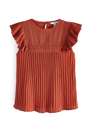 Rust orange sleeveless blouse with pleated body, lace panel on chest, and ruffled shoulder accents, featuring a round neckline with back button.