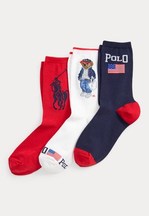 Punased, valged ja mereväesinised sokid Polo Ralph Laureni disainidega: ratsutaja, riietatud karu ja Ameerika lipp koos tekstiga "POLO".