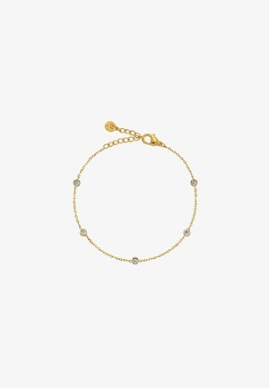 Náramok zlatého reťazca so štyrmi rovnomerne rozmiestnenými akcentmi z čírych kameňov, s karabínovým zapínaním a nastaviteľnou dĺžkou. Textúrované články pridávajú zaujímavosť.