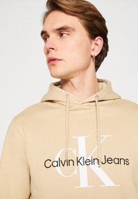 Calvin Klein Jeans SEASONAL MONOLOGO REGULAR HOODIE - Felpa - pale khaki