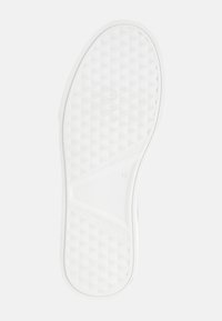 Suola di scarpa bianca con superficie texturizzata che presenta un motivo di piccoli triangoli. Marcatura di taglia '42' visibile sul lato.