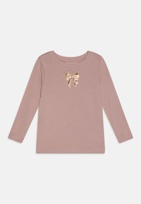 T-shirt rose clair à manches longues en tissu doux, ornée d'un détail en sequins dorés en forme de nœud au centre devant. Encolure ronde, design basique.