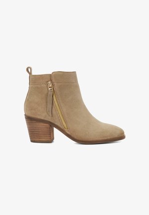 Tan suede ankle boot with a pointed toe, gold side zipper, and stacked wooden heel. Smooth texture and minimalistic design.