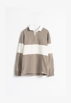 Camisa polo de manga larga en algodón beige y blanco, con rayas horizontales, un cuello blanco y un pequeño detalle de logo en el pecho.