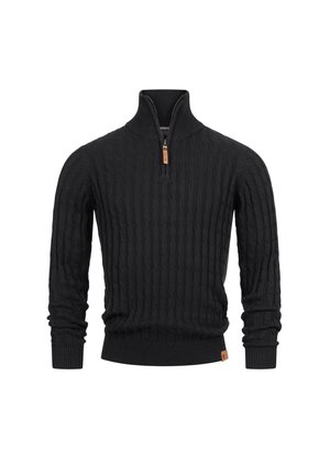 Mustan neulotun villapuseron korkea kaulus ja puolivetoketju, jossa on kabelineulekuvio ja ribbikujat hihoissa jahelmassa. Nahkainen logo-etiketti helmassa.