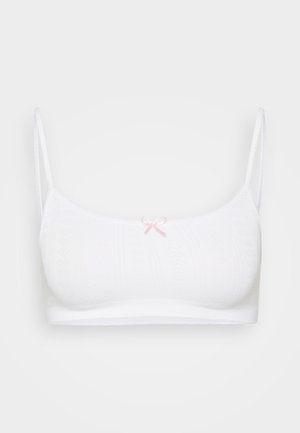 White bralette featuring a textured knit design, adjustable straps, and a small pink bow detail at the center front.