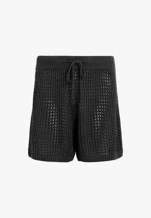 Zwarte gebreide shorts met een losse weefpatroon, elastische trekkoord taille en zijsplitsen. Zacht van textuur met een ontspannen pasvorm.