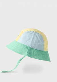 Chapeau bob pastel avec des panneaux jaunes, bleus et verts, arborant un bord cousu vert et une lanière de menton verte ajustable nouée en un nœud.