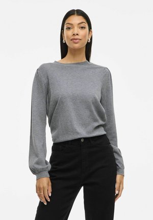 Gray long-sleeve sweater with a crew neckline and puffed sleeve detail. Paired with black high-waisted jeans for a contrasting look.