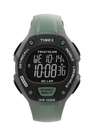 Timex digitalni sportski sat s zelenom narukvicom, prikazuje vrijeme 10:08:36, datum srijeda 10-14, te gumbe označene kao način, start/krvni razdjeljak, stop/reset.