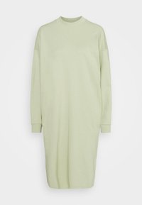 Jasnozielona, oversize sukienka wykonana z miękkiego materiału, z wysokim dekoltem i długimi rękawami z ribbowymi mankietami, gładką fakturą i minimalistycznym designem.