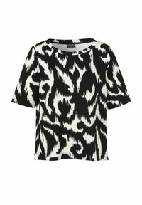 Haut à manches courtes noir et blanc présentant un motif abstrait. Fabriqué dans un tissu lisse avec une coupe ample et un col rond.