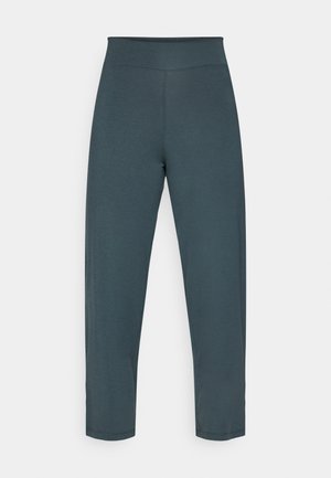 Weiche, dehnbare tealfarbene Leggings mit hohem Bund, cropped Länge und glatter Textur. Minimale Nähte und keine zusätzlichen Beschläge.