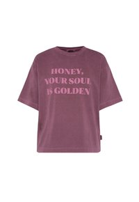 Oversized lavender t-shirt made of soft cotton, featuring bold pink text that reads "HONEY, YOUR SOUL IS GOLDEN." Short sleeves and relaxed fit.