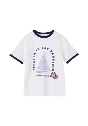 White short-sleeve T-shirt with navy collar and sleeve edges, featuring a sailboat graphic and "Regatta in the Hamptons Long Island" text.