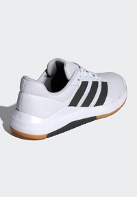 Hvide atletiske sko med en mesh-overdel, sorte tre striber og en gummisål med en gummifarvet detalje. Teksturfinish og polstret krave.