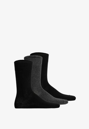 Drei Paar Socken in unterschiedlichen Farbtönen: zwei einfarbige schwarze Paare an den Seiten und ein dunkelgraues Paar in der Mitte mit einem gerippten Bündchen.