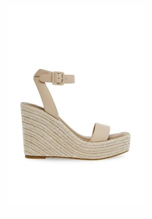 Sandale compensée beige avec plateforme en corde tressée, bride de cheville avec boucle et design à bout ouvert.