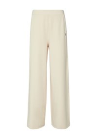 Pantalon large de couleur crème en tissu doux et extensible. Dispose d'une taille élastique et d'un petit logo en forme de cœur sur le côté.