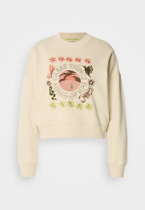 Sweatshirt court couleur crème avec un graphisme rond représentant des plantes, un coucher de soleil, et le texte "DE GRANDES CHOSES VOUS ATTENDENT" en couleurs variées.
