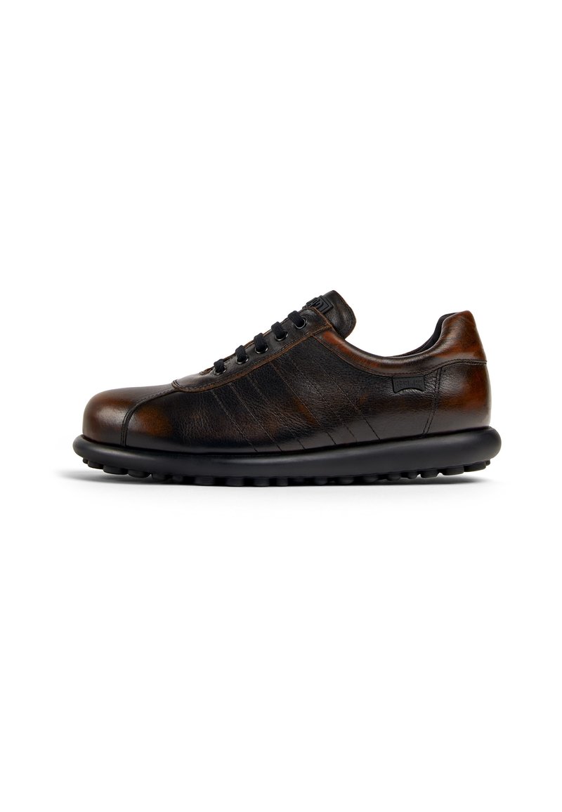 Brown leather sneaker with a rounded toe, black laces, textured sides, and a lightweight black sole featuring small circular grips.