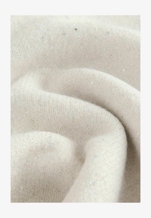 Close-up of soft beige knitted fabric with subtle shimmering fibers and gentle folds.