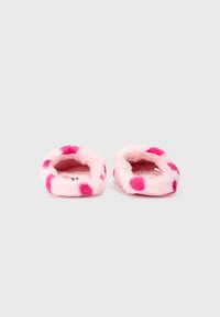 Pink fuzzy slippers with polka dot pattern in darker pink, plush texture, open back design, and rounded shape. No visible hardware.