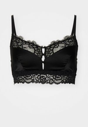 Black bralette featuring a smooth satin finish, lace detailing along the top and bottom edges, and a central keyhole accent. Adjustable straps.